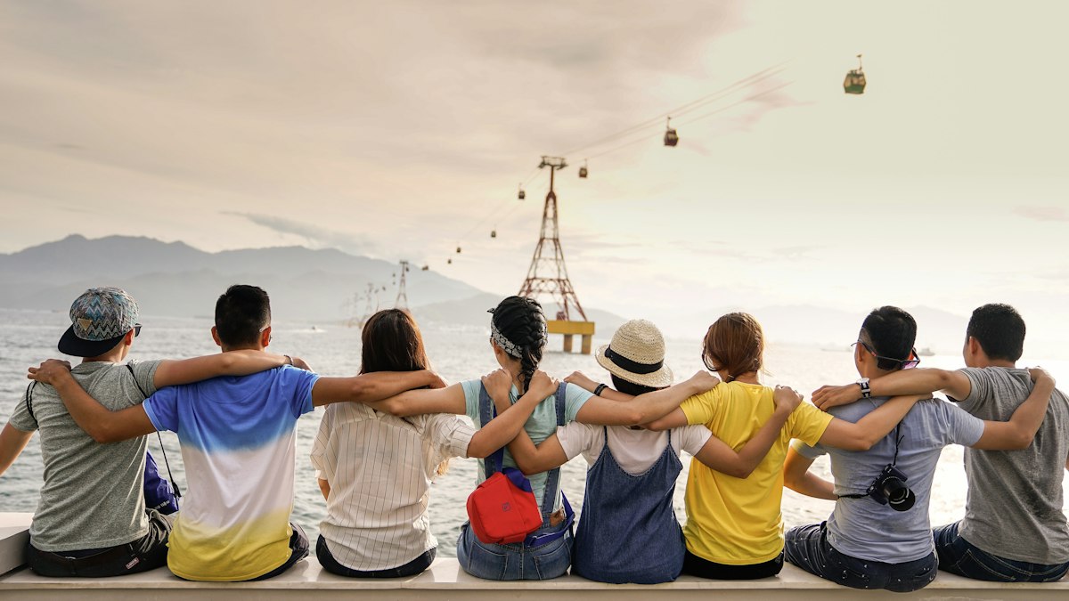 Escapadas Baratas con Amigos por España y Europa Grupo de amigos sonriendo y celebrando en un viaje por carretera y naturaleza